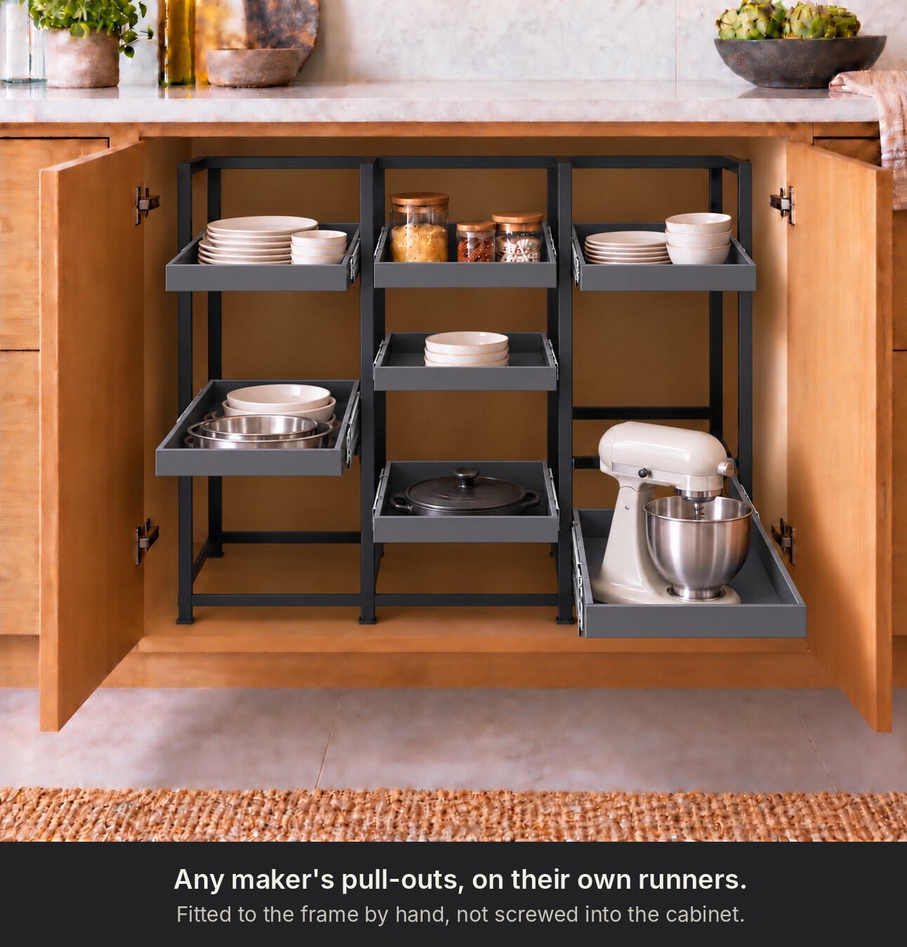 CabZone: One frame. Every base cabinet. The same frame in use, holding cast iron cookware on pull out shelves
